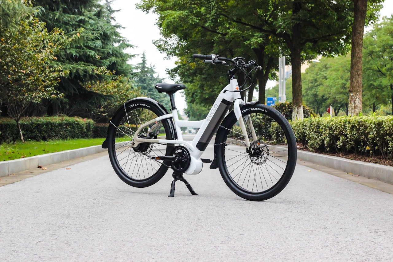 A used electric motorcycle plugged into a charging cable inside a home garage