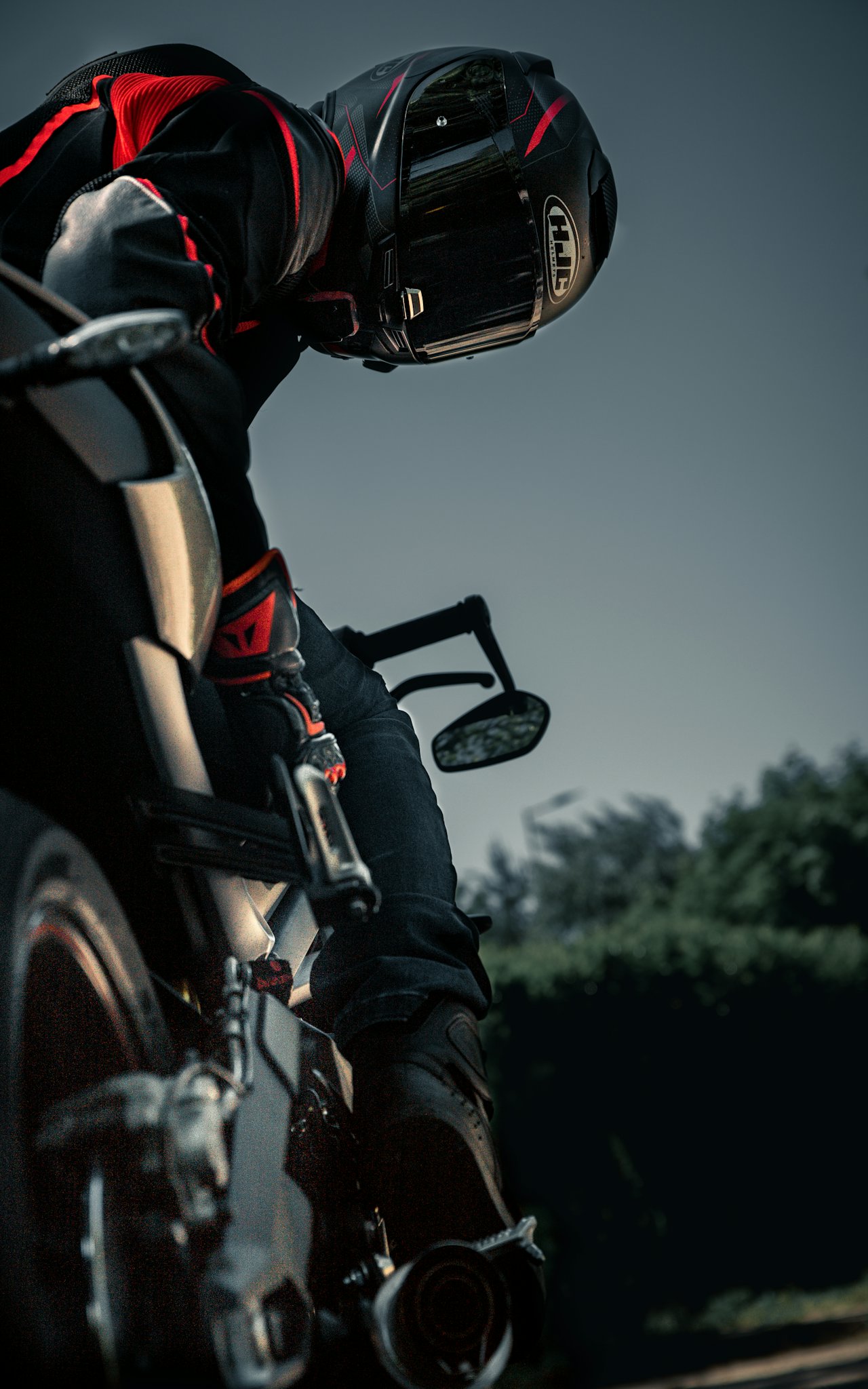 Electric naked motorcycle parked on a rain-slicked city street at dusk