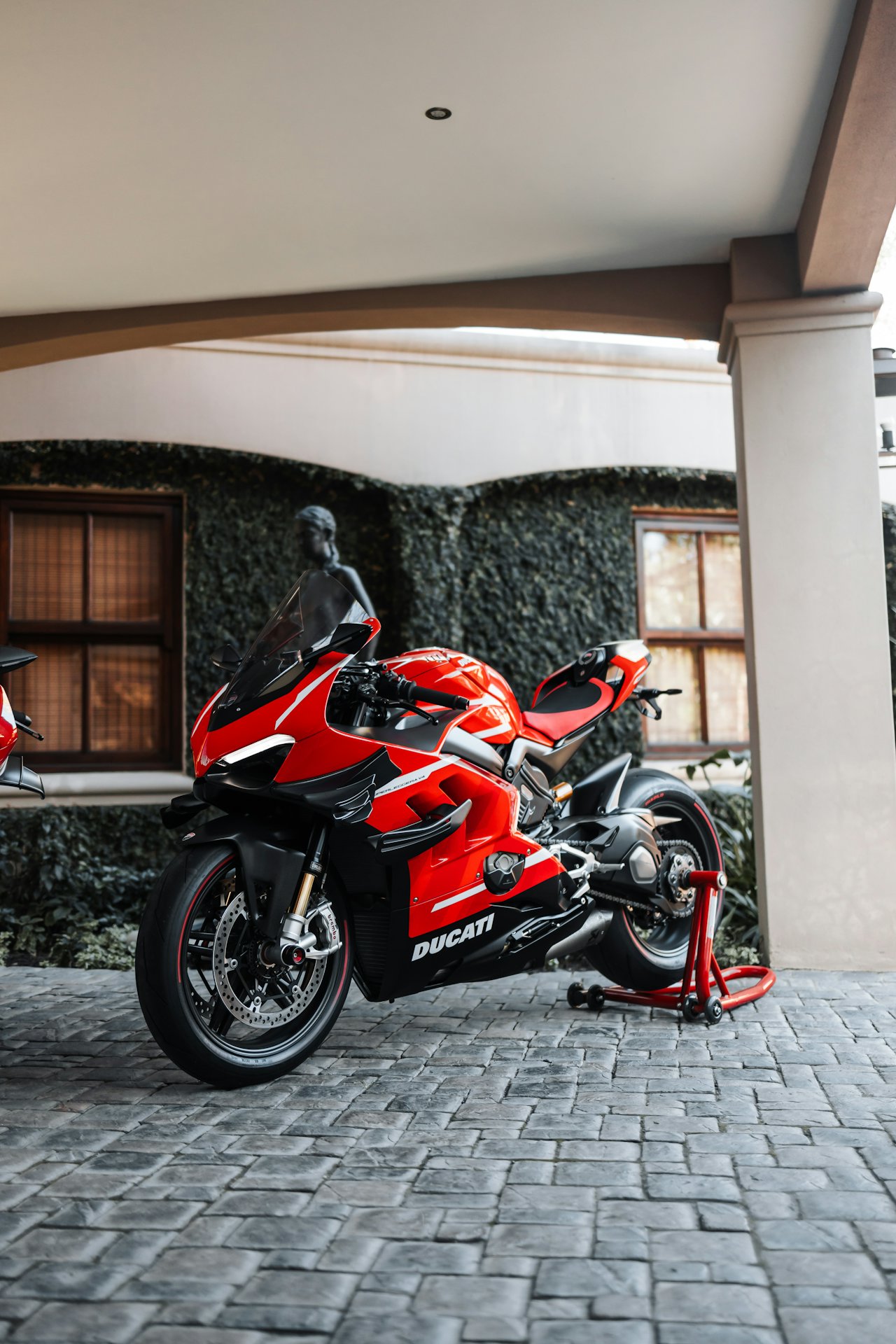 Red Ducati Panigale V4 superbike parked on cobblestones