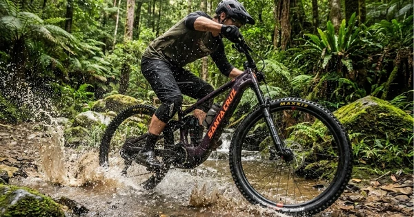 Riding the Santa Cruz Vala 90 through a jungle creek crossing.